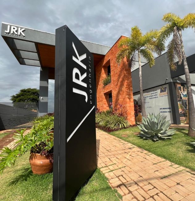 Fachada do prédio da JRK Engenharia com paisagismo e placa de identificação